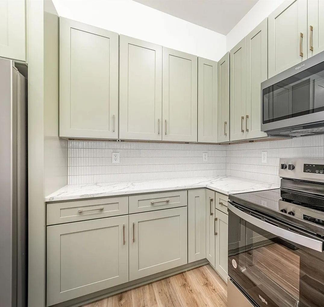 Compact kitchen with D3 Shallow Green shaker cabinets and white tile backsplash