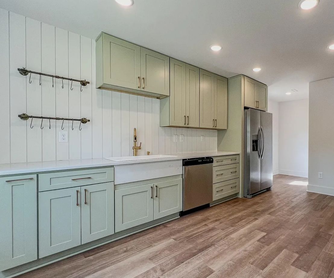 Kitchen with D3 Shallow Green shaker cabinets, white counters and stainless appliances