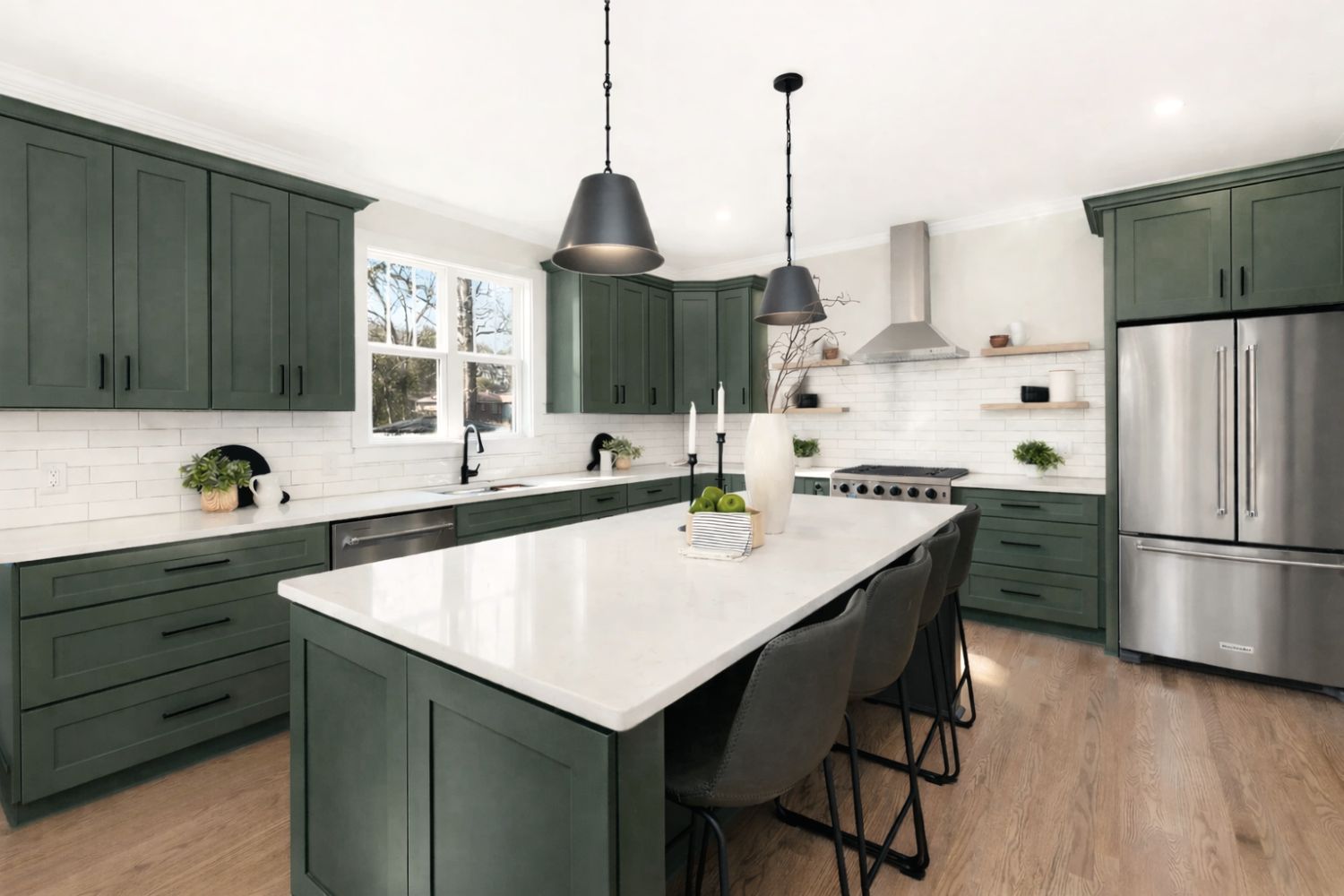 Kitchen with D7 Forest Green shaker cabinets, white quartz island and black pendant lights