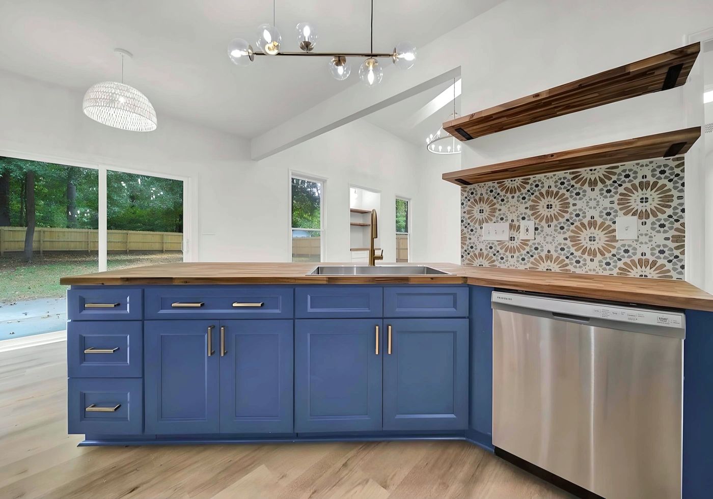 Kitchen with a G8 blue island, butcher-block top and patterned tile backsplash