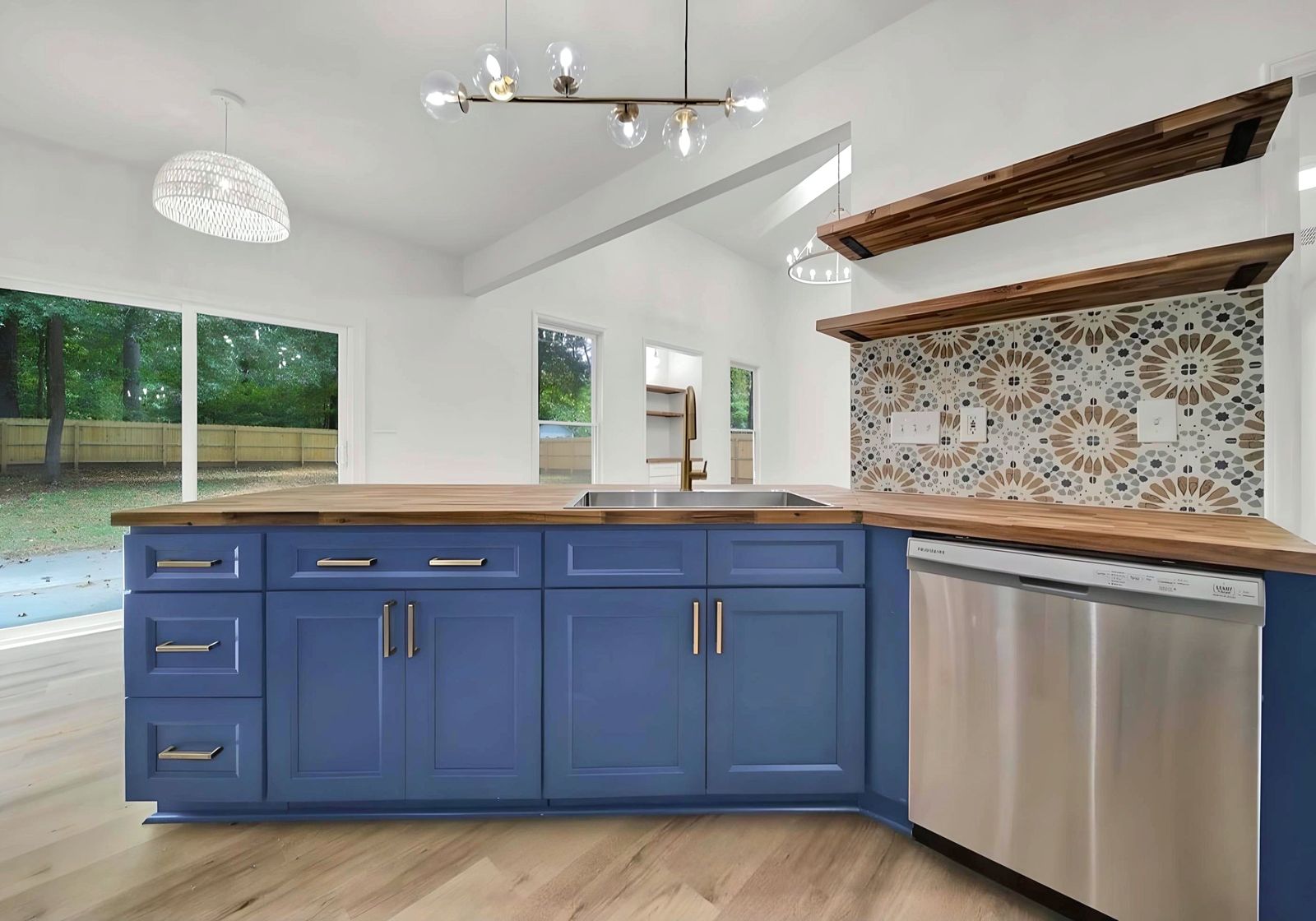 Kitchen with a G8 blue island, butcher-block top and patterned tile backsplash