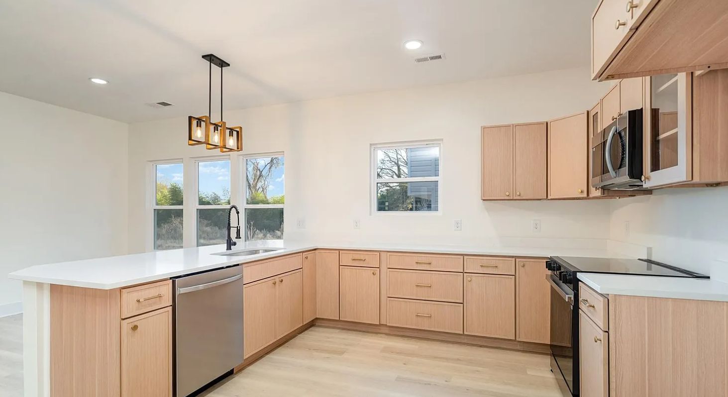 Kitchen with M2 Sandstone light wood cabinets and white quartz counters