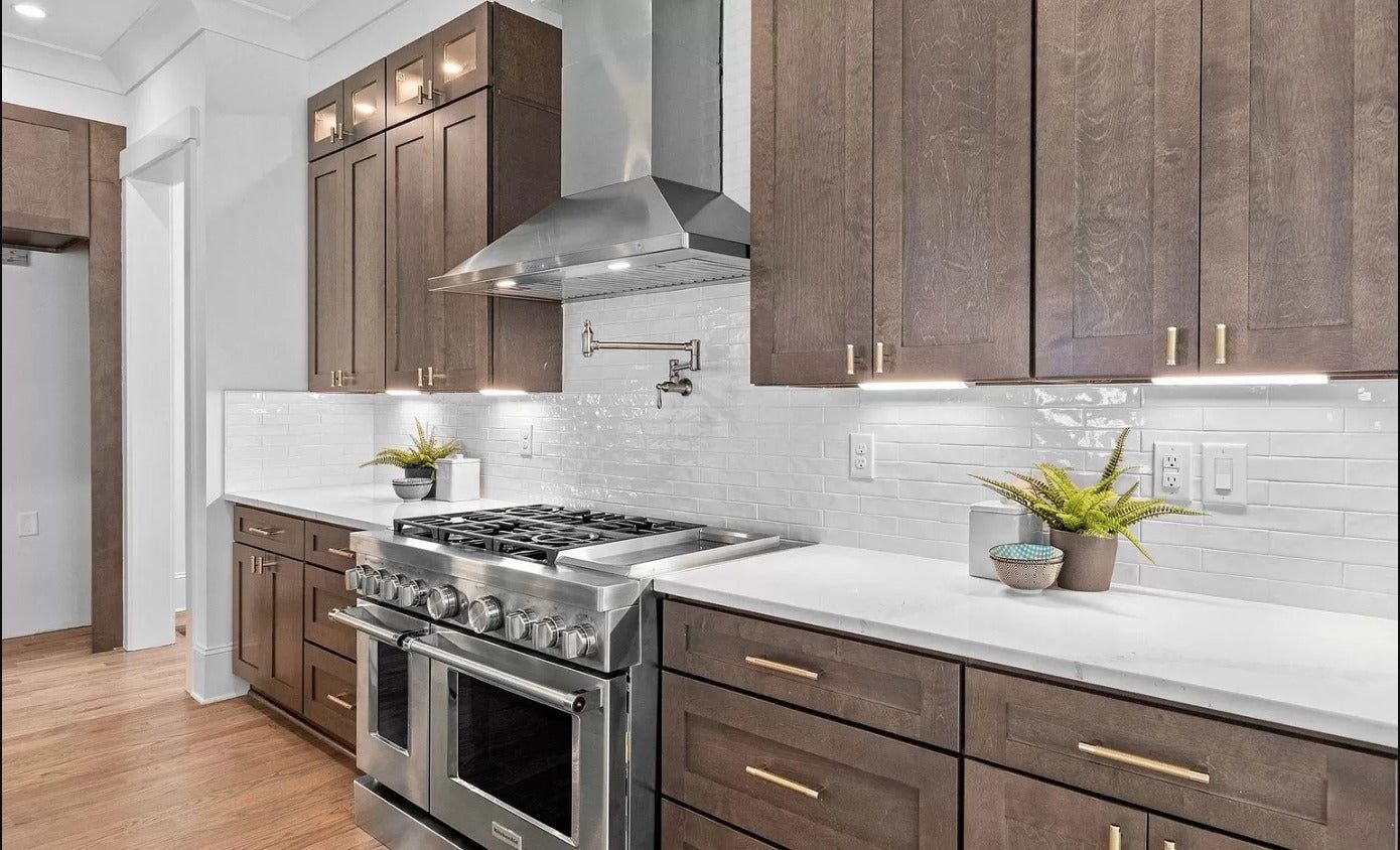 Kitchen with S1 Ash Grey wood-grain cabinets, white tile backsplash and professional range