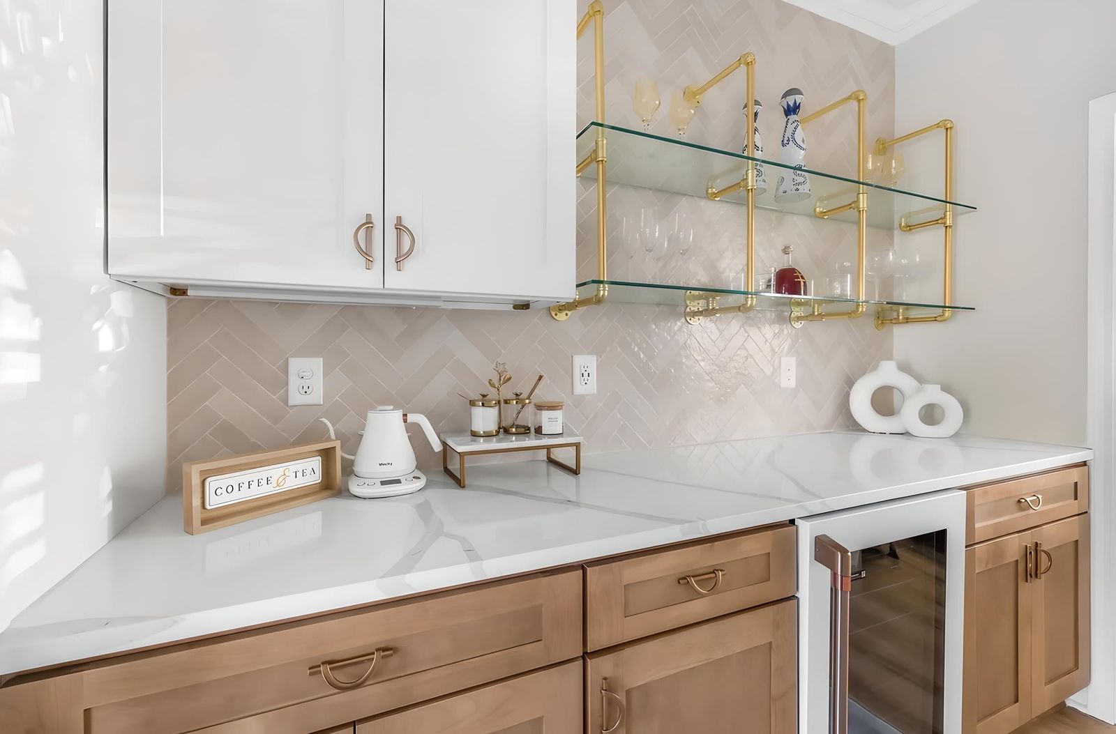 Kitchen with white uppers and S1 Ash Grey wood-grain base cabinets, gold shelving and wine fridge