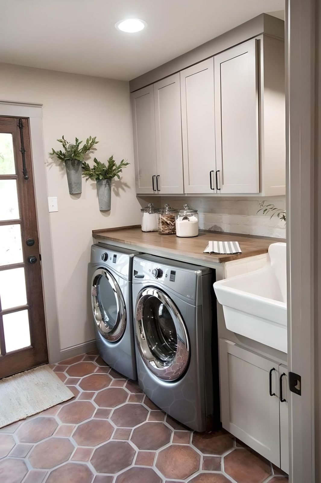 Laundry room with D6 Dove Grey shaker cabinets, farmhouse sink and terracotta tile floor