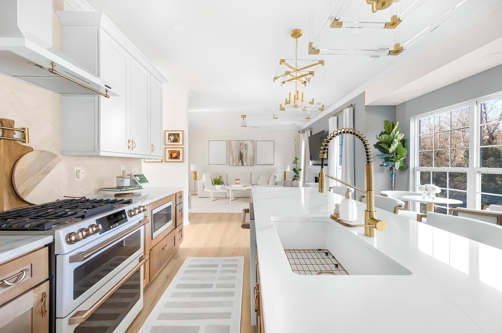 White shaker kitchen with natural oak accents, brass faucet and gold sputnik chandelier